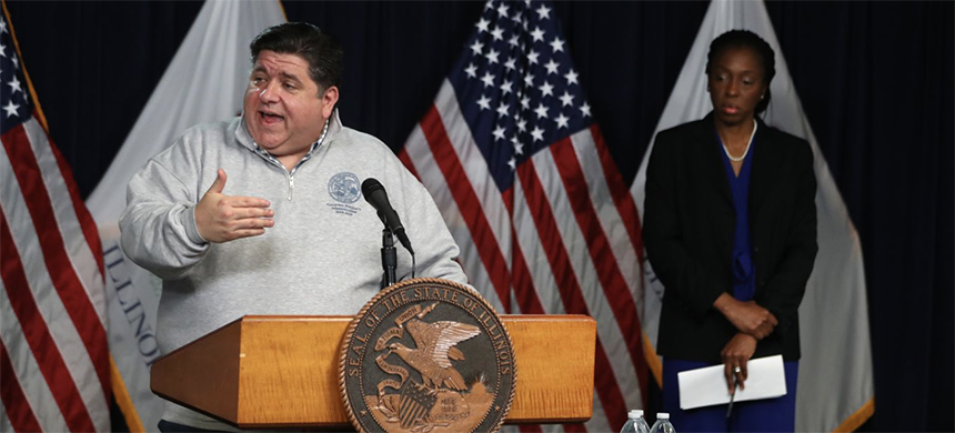 Illinois Gov. J.B. Pritzker speaks at his daily coronavirus briefing from the Thompson Center in Chicago, on March 28, 2020. At right is Dr. Ngozi Ezike, Illinois Dept. of Public Health director. (photo: Chris Sweda/Chicago Tribune)