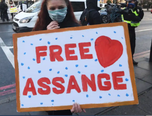 Sign held by a Julian Assange supporter. Photo: Facundo Arrizabalaga/EPA